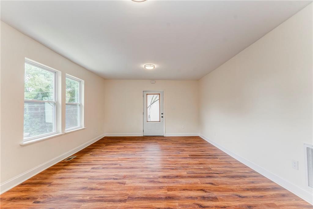 310 Kingston Avenue Northeast Rome, GA 30161 - Photo 18 of 45 a view of an empty room with wooden floor and a window