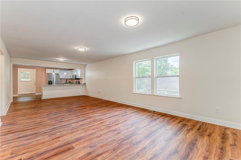 310 Kingston Avenue Northeast Rome, GA 30161 - Photo 19 of 45 an empty room with wooden floor and windows