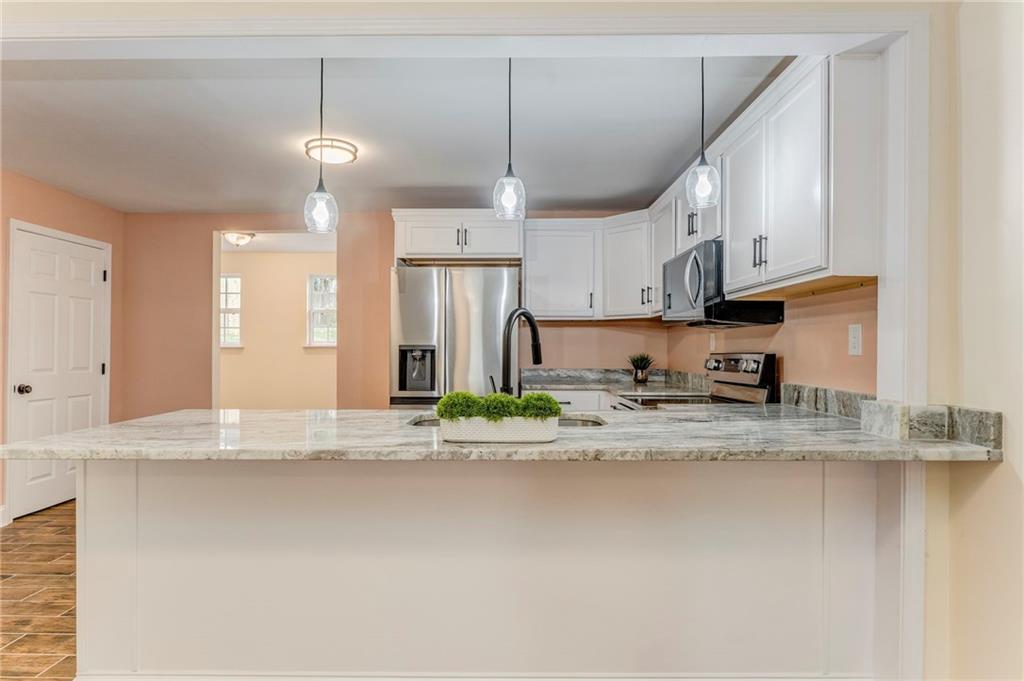 310 Kingston Avenue Northeast Rome, GA 30161 - Photo 25 of 45 a view of a kitchen with stainless steel appliances granite countertop a sink refrigerator and cabinets