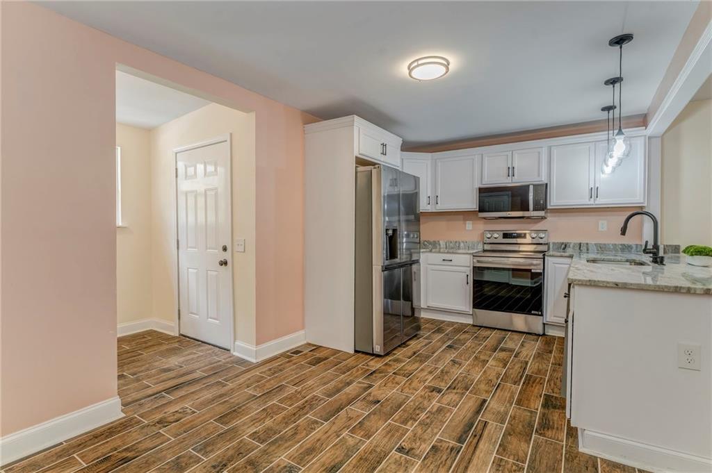 310 Kingston Avenue Northeast Rome, GA 30161 - Photo 29 of 45 a kitchen with granite countertop a refrigerator stove and sink
