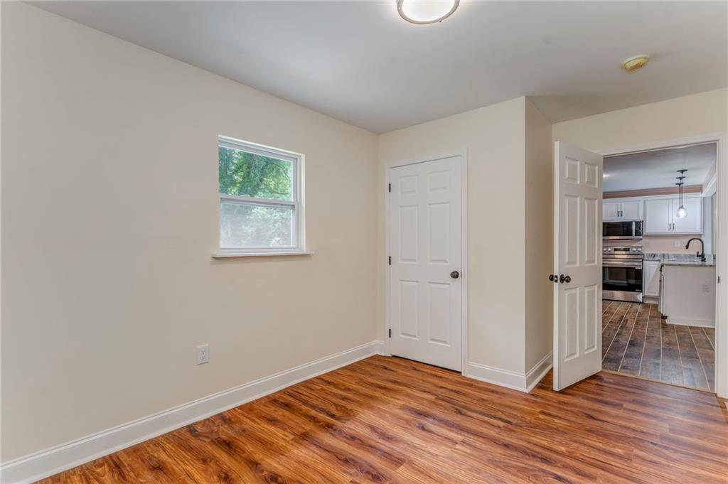 310 Kingston Avenue Northeast Rome, GA 30161 - Photo 34 of 45 a view of a room with wooden floor and a kitchen