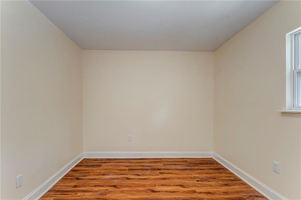 310 Kingston Avenue Northeast Rome, GA 30161 - Photo 35 of 45 a view of an empty room with wooden floor and a window