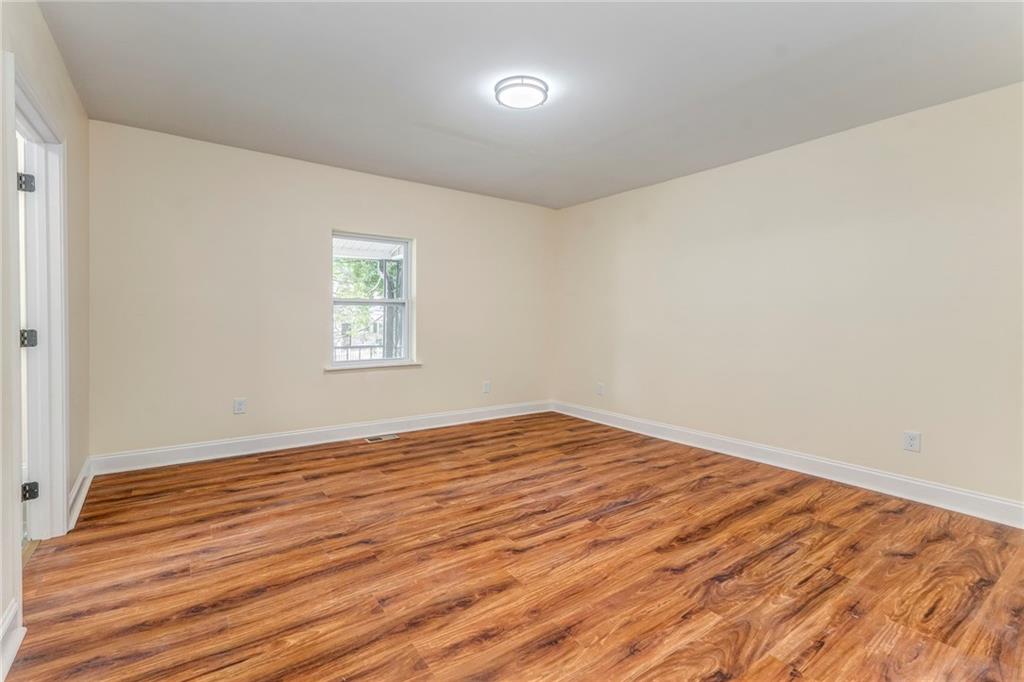 310 Kingston Avenue Northeast Rome, GA 30161 - Photo 8 of 45 wooden floor in an empty room with a window