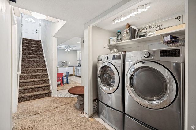 1215 8th Street Ogden, UT 84404 - Photo 34 of 39 Dedicated laundry area featuring front-loading washer and dryer units with storage shelving above