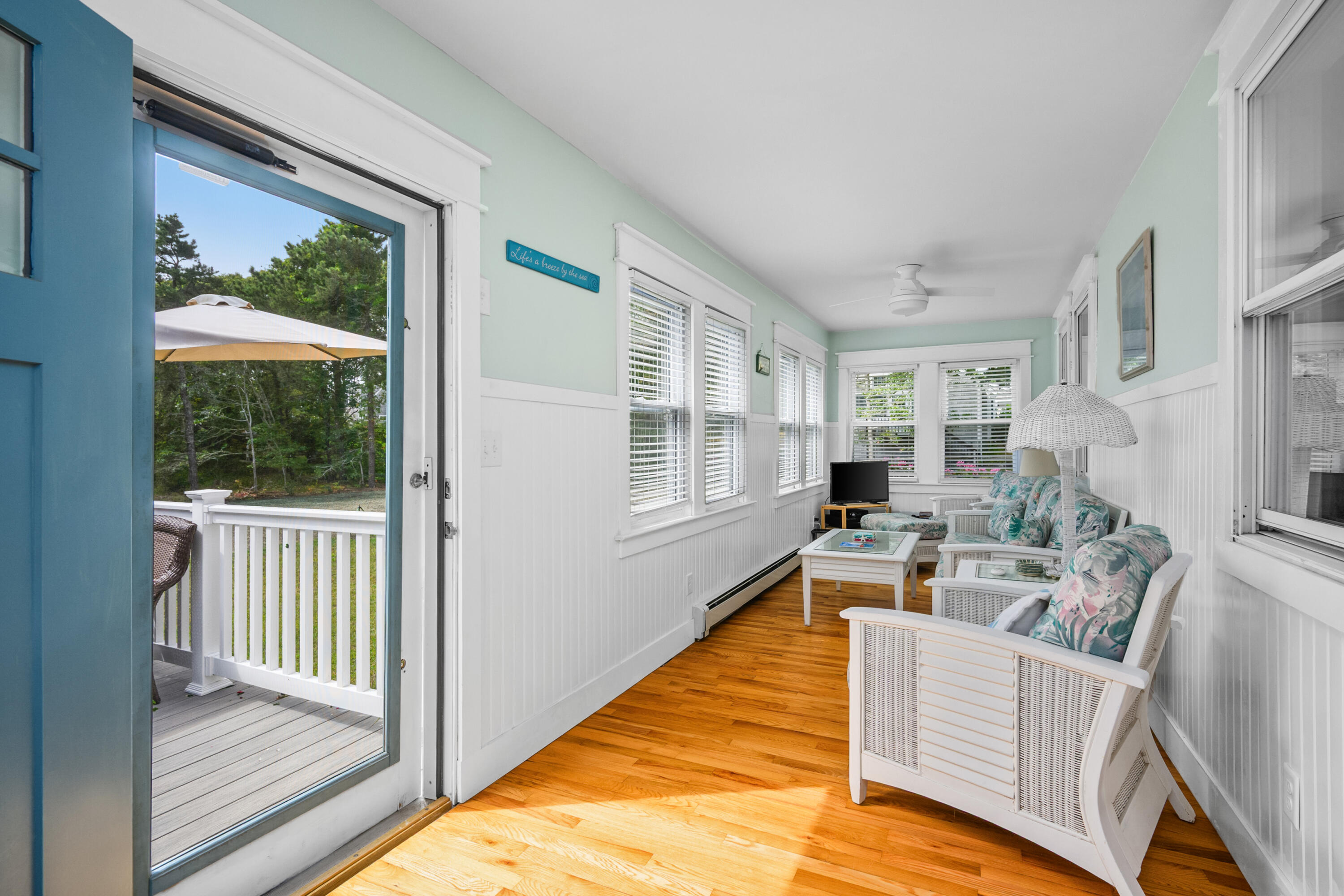 79 Forest Beach Road South Chatham, MA 02659 - Photo 16 of 60 a living room with furniture wooden floor and a large window