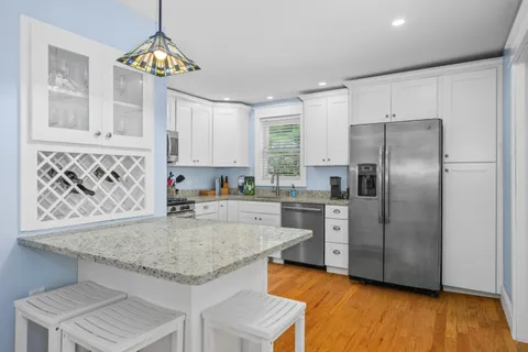 a kitchen with stainless steel appliances granite countertop a stove a sink and a refrigerator
