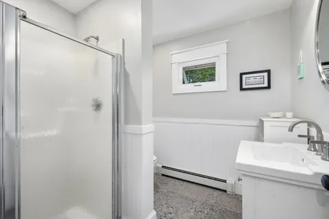 a bedroom with a bed and a flat tv screen on the dresser