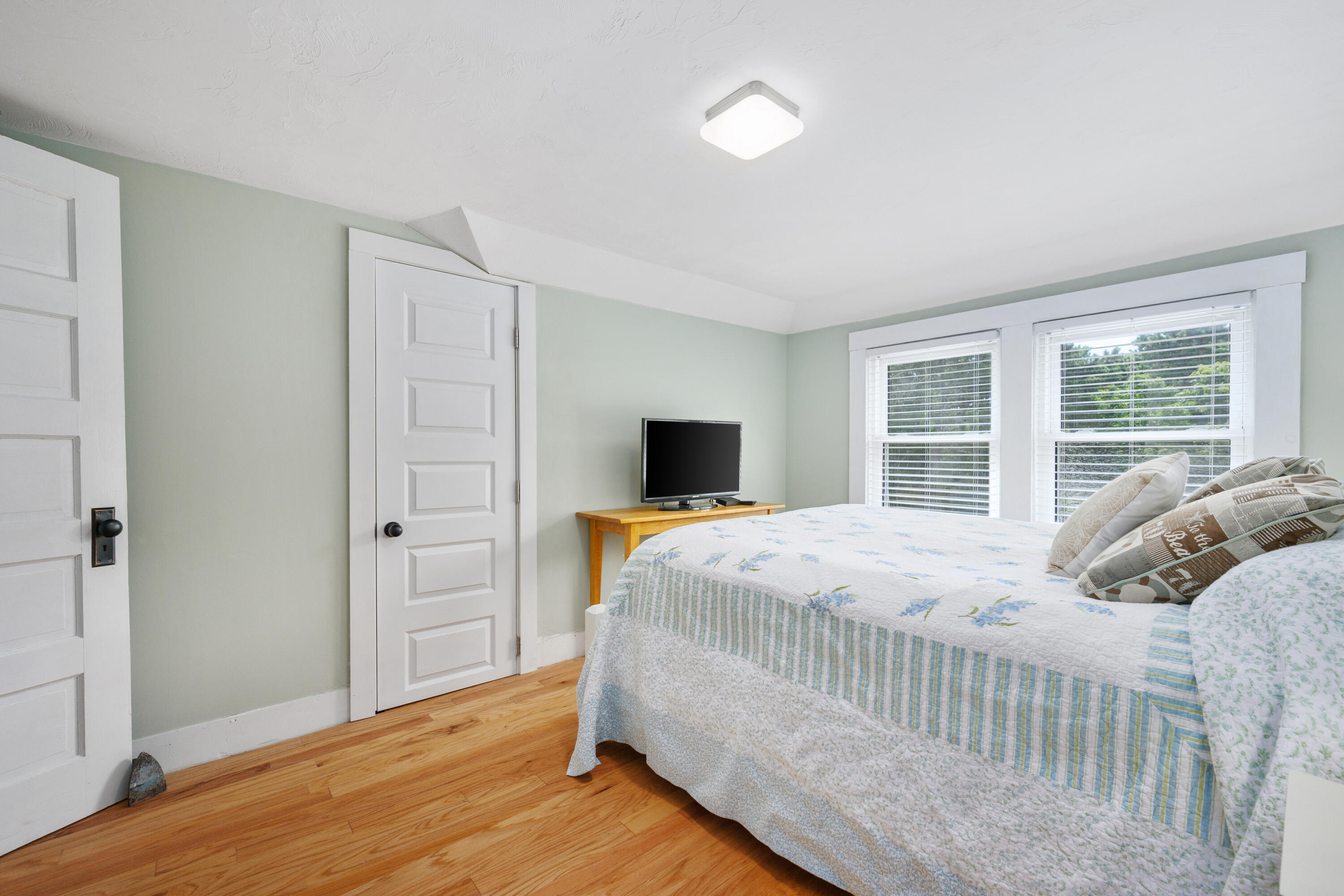 79 Forest Beach Road South Chatham, MA 02659 - Photo 27 of 60 a bedroom with a bed and wooden floor