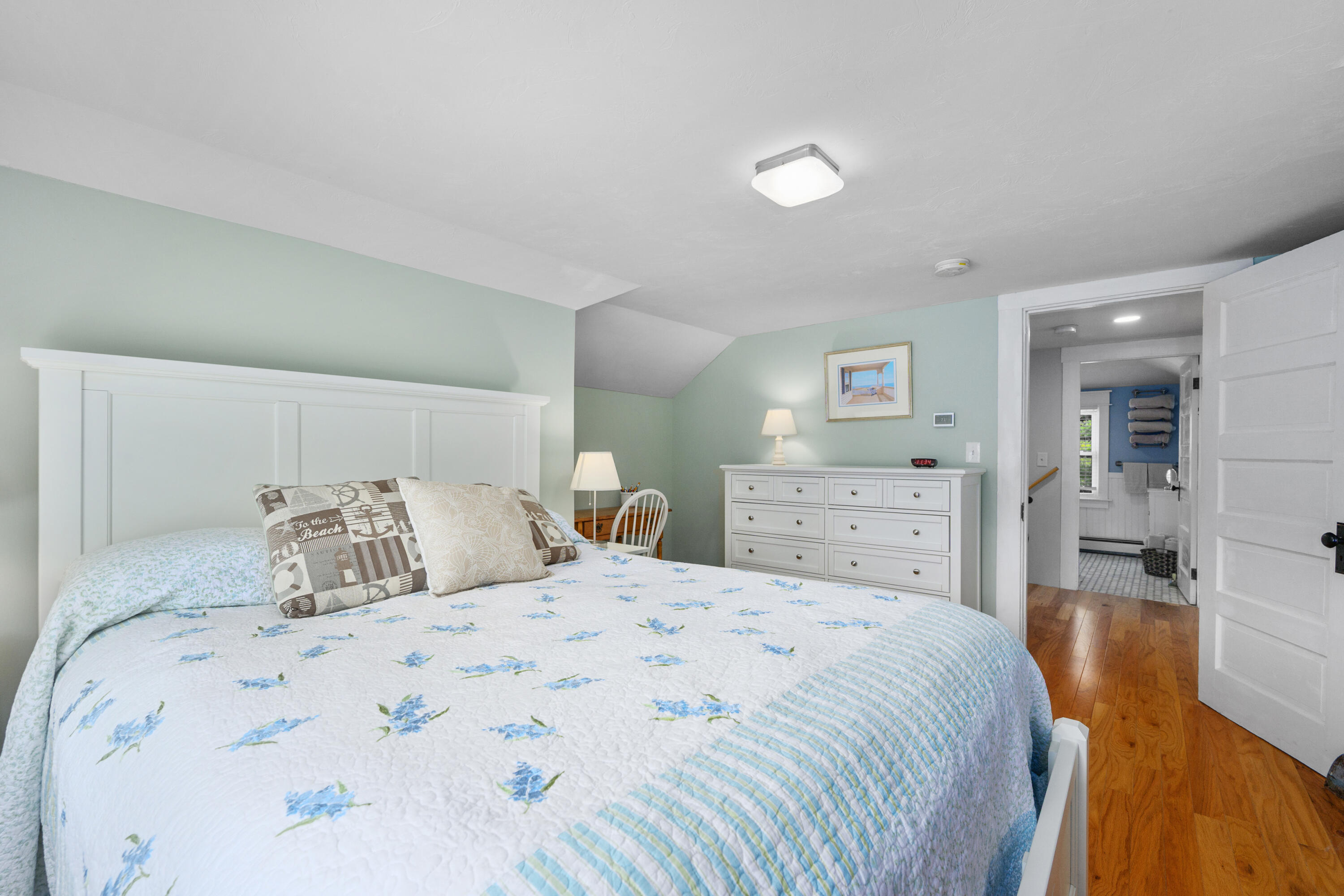 79 Forest Beach Road South Chatham, MA 02659 - Photo 28 of 60 a bedroom with a large bed and a wooden floor
