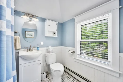 a view of a house with a yard and potted plants