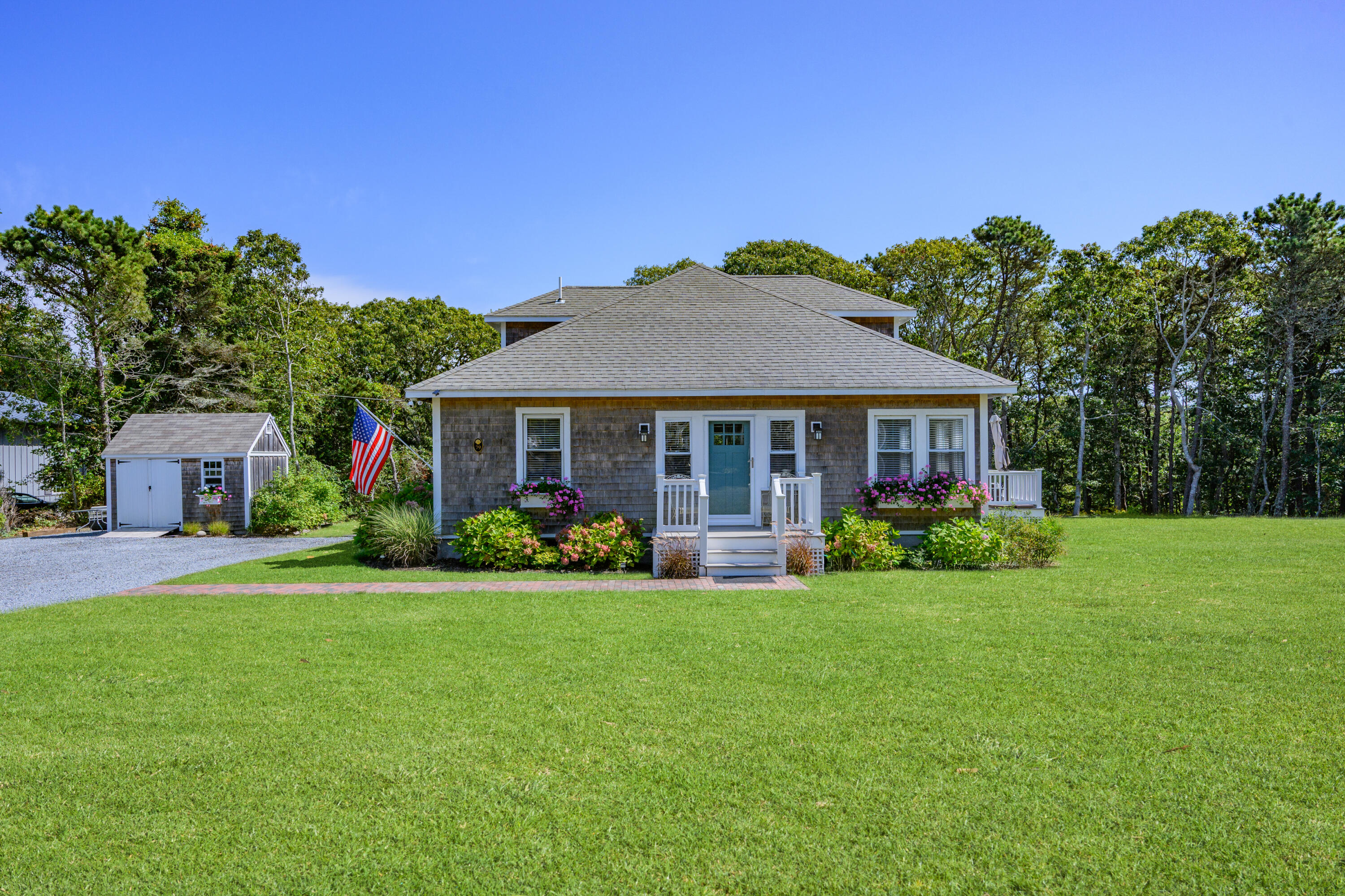 79 Forest Beach Road South Chatham, MA 02659 - Photo 34 of 60 a front view of a house with a yard table and chairs