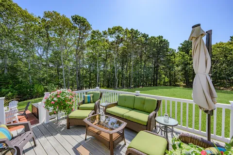 a view of backyard of house with seating space