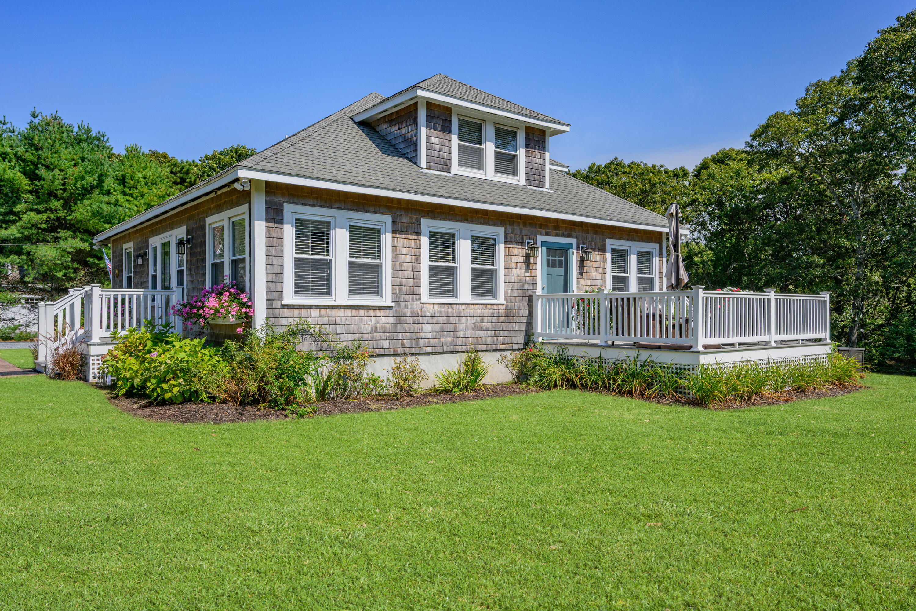79 Forest Beach Road South Chatham, MA 02659 - Photo 4 of 60 a front view of a house with a yard