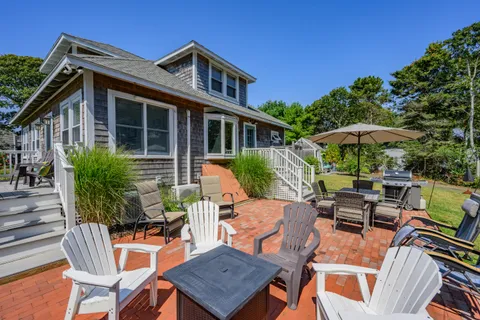 a view of a house with a yard and sitting area