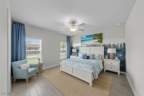 a view of a hallway with wooden floor kitchen view and a window