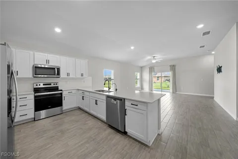 a spacious bathroom with a double vanity sink a toilet and a mirror