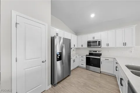 a bathroom with a double vanity sink toilet mirror and shower