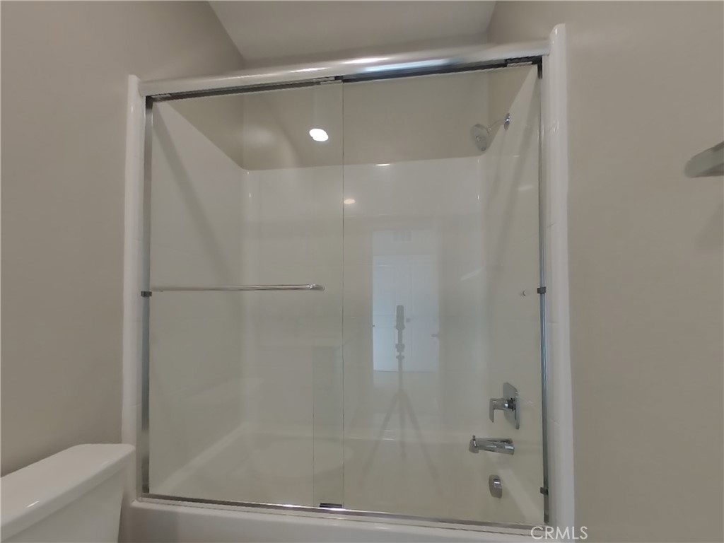 24967 Padre Court Wildomar, CA 92595 - Photo 13 of 30 a bathroom with a glass shower door