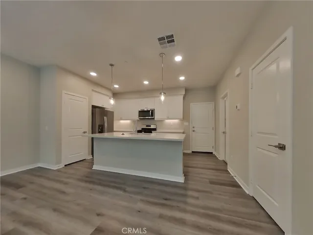 a view of kitchen with sink microwave and refrigerator