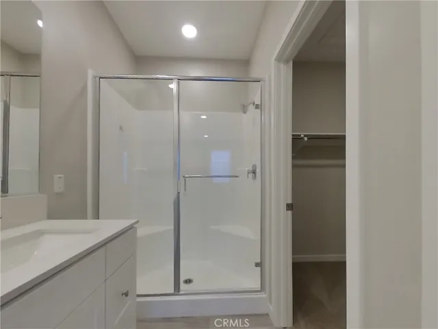 a view of an empty room with closet and a window