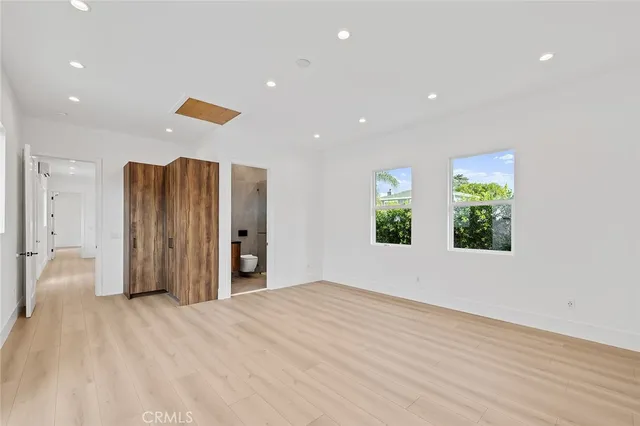 a view of a livingroom with wooden floor and window