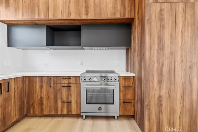 a kitchen with granite countertop a stove and a microwave