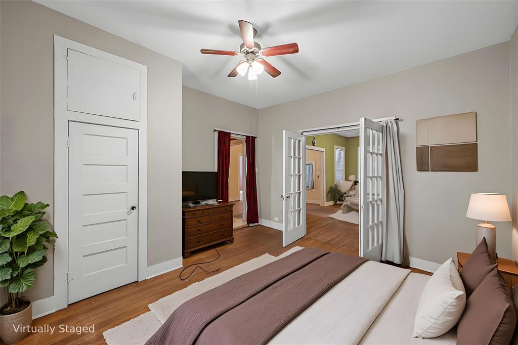 2623 North 15th A Street Waco, TX 76708 - Photo 11 of 23 a bedroom with a bed and a chandelier