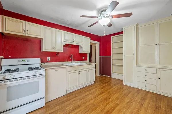 a kitchen with a stove a sink and a refrigerator