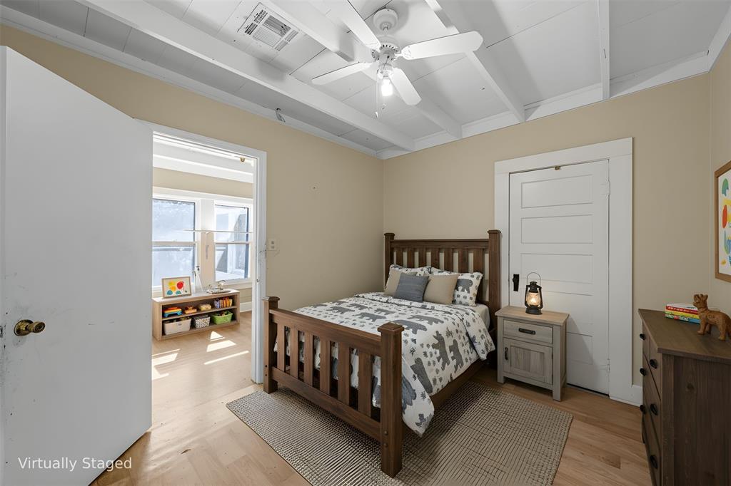 2623 North 15th A Street Waco, TX 76708 - Photo 17 of 23 a bedroom with a bed and a chandelier