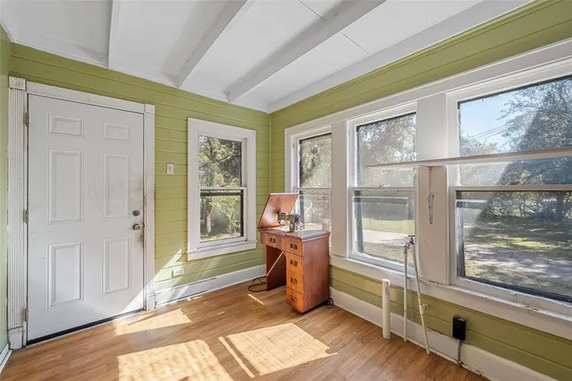 a view of an entryway with wooden floor and windows