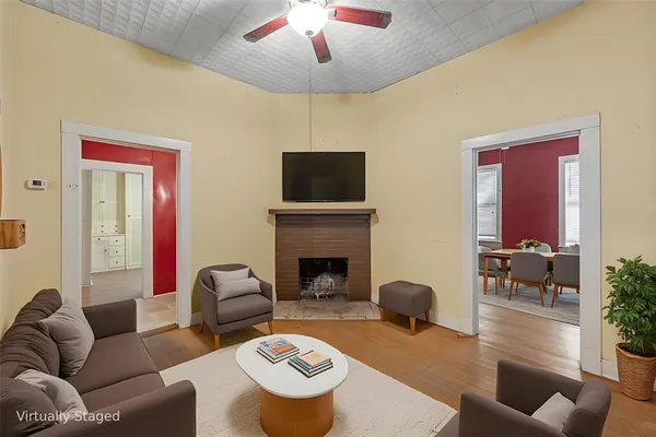 a living room with furniture a fireplace and a flat screen tv