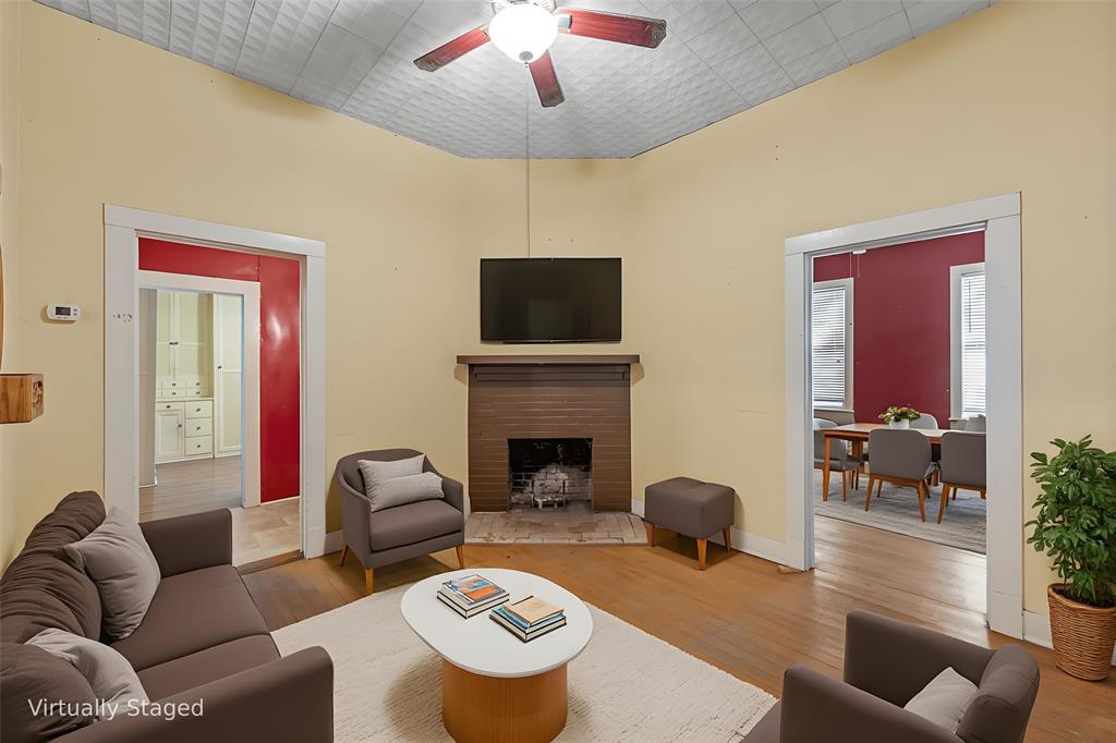 2623 North 15th A Street Waco, TX 76708 - Photo 3 of 23 a living room with furniture a fireplace and a flat screen tv