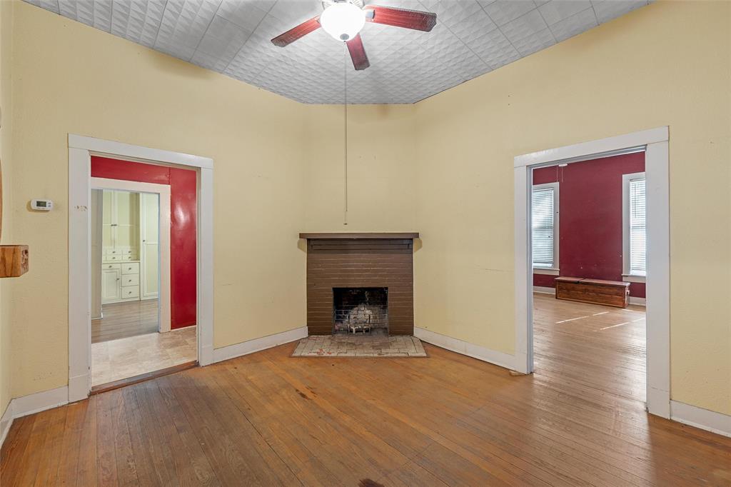 2623 North 15th A Street Waco, TX 76708 - Photo 4 of 23 a view of an empty room with wooden floor fireplace and a window