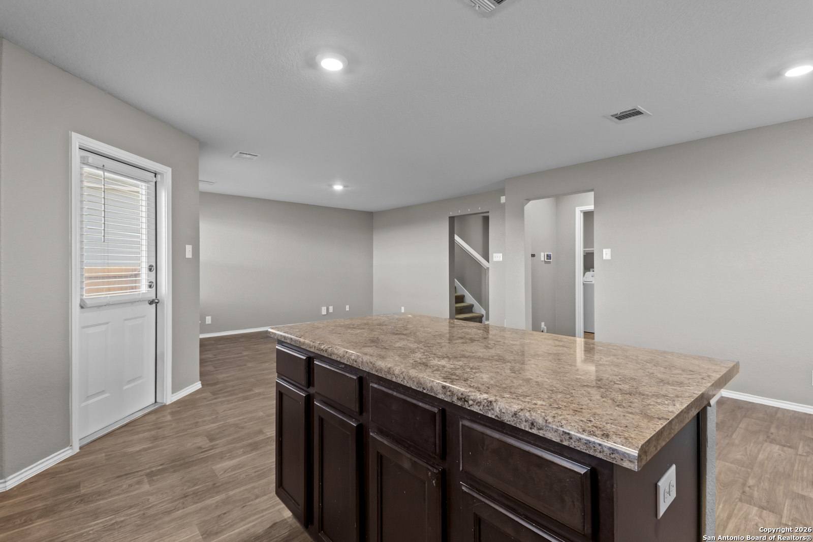 4106 Winterfell Pass Converse, TX 78109 - Photo 11 of 31 a kitchen with kitchen island a counter top space and a sink