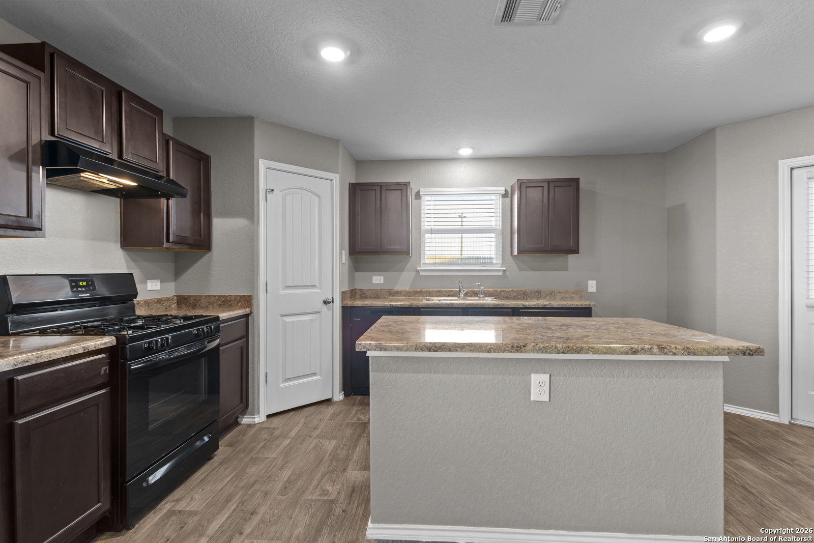 4106 Winterfell Pass Converse, TX 78109 - Photo 13 of 31 a kitchen with a stove and a sink