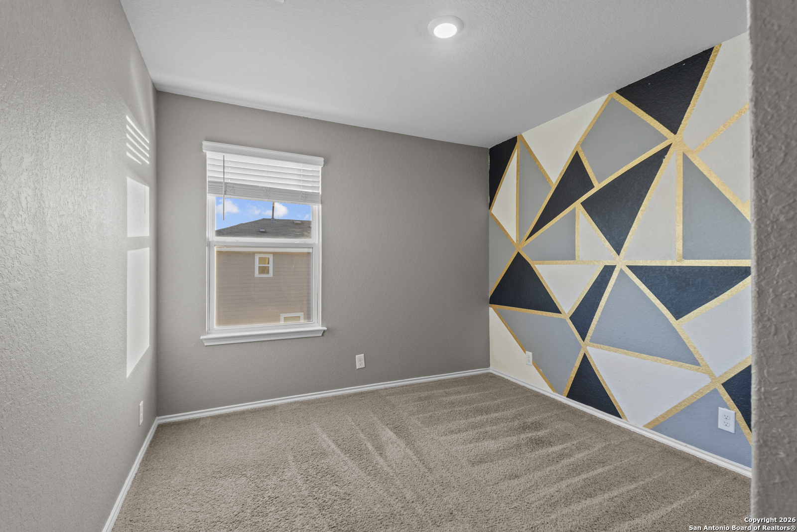 4106 Winterfell Pass Converse, TX 78109 - Photo 26 of 31 an empty room with wooden floor and windows