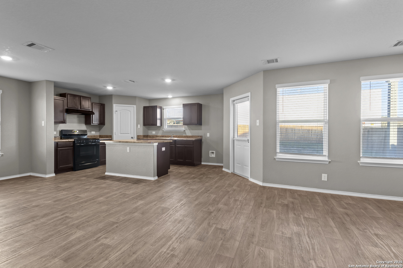 4106 Winterfell Pass Converse, TX 78109 - Photo 8 of 31 a large kitchen with a stove a sink a refrigerator a window and a kitchen island
