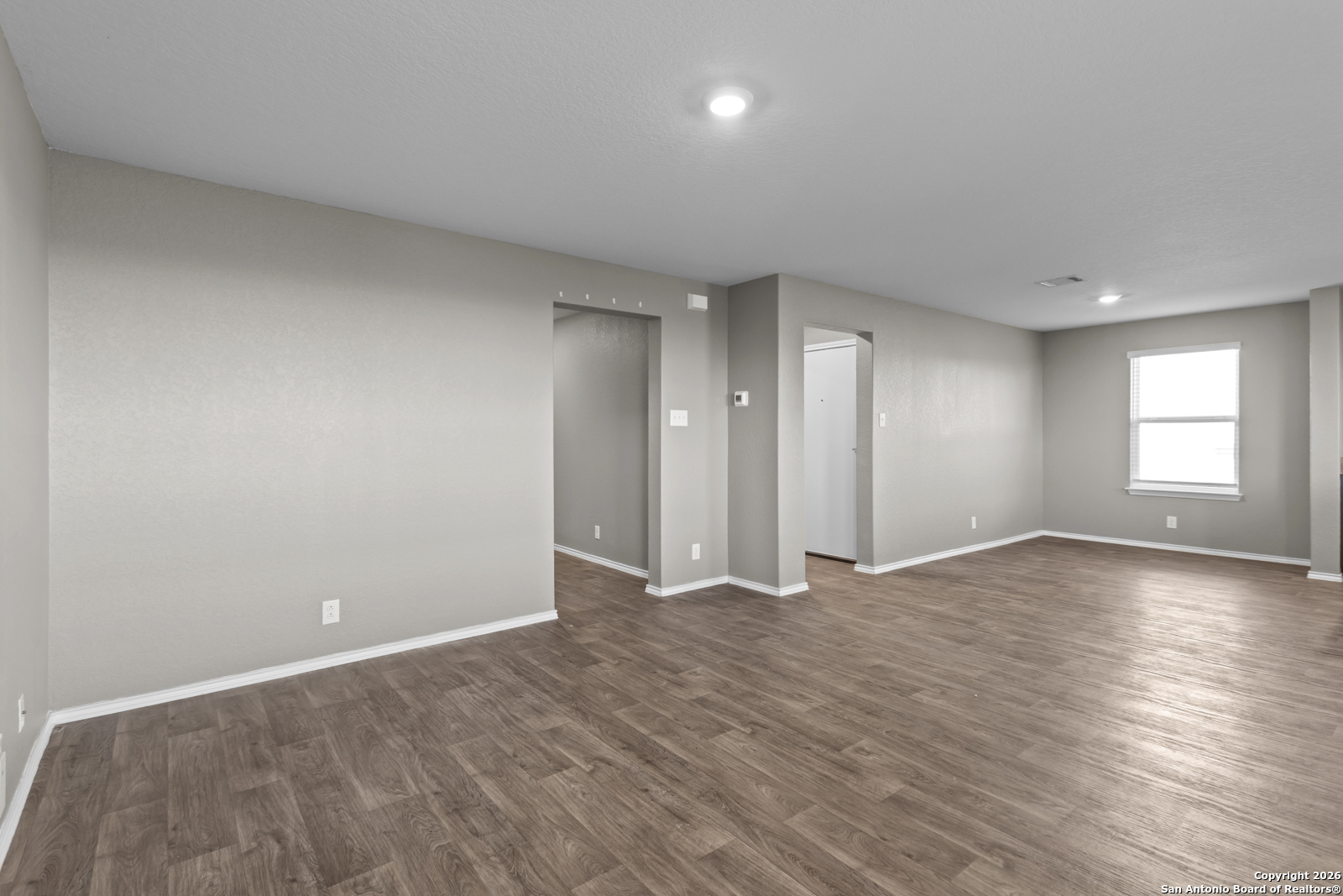 4106 Winterfell Pass Converse, TX 78109 - Photo 9 of 31 a view of an empty room with wooden floor and window