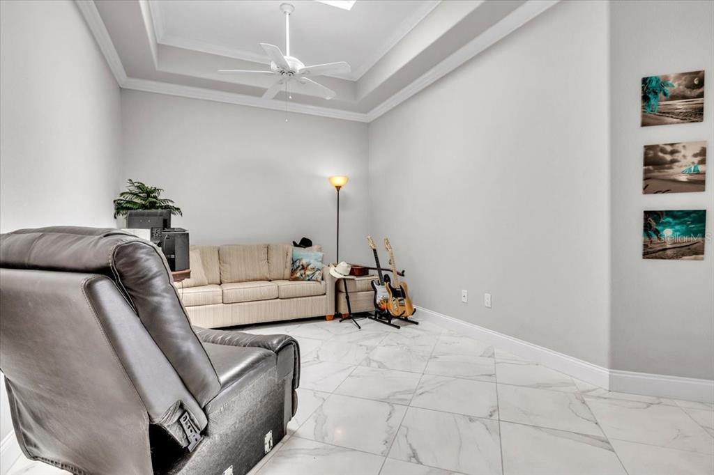 1260 Rio De Janeiro Avenue, Unit 102 Punta Gorda, FL 33983 - Photo 21 of 46 a living room with furniture and a chandelier