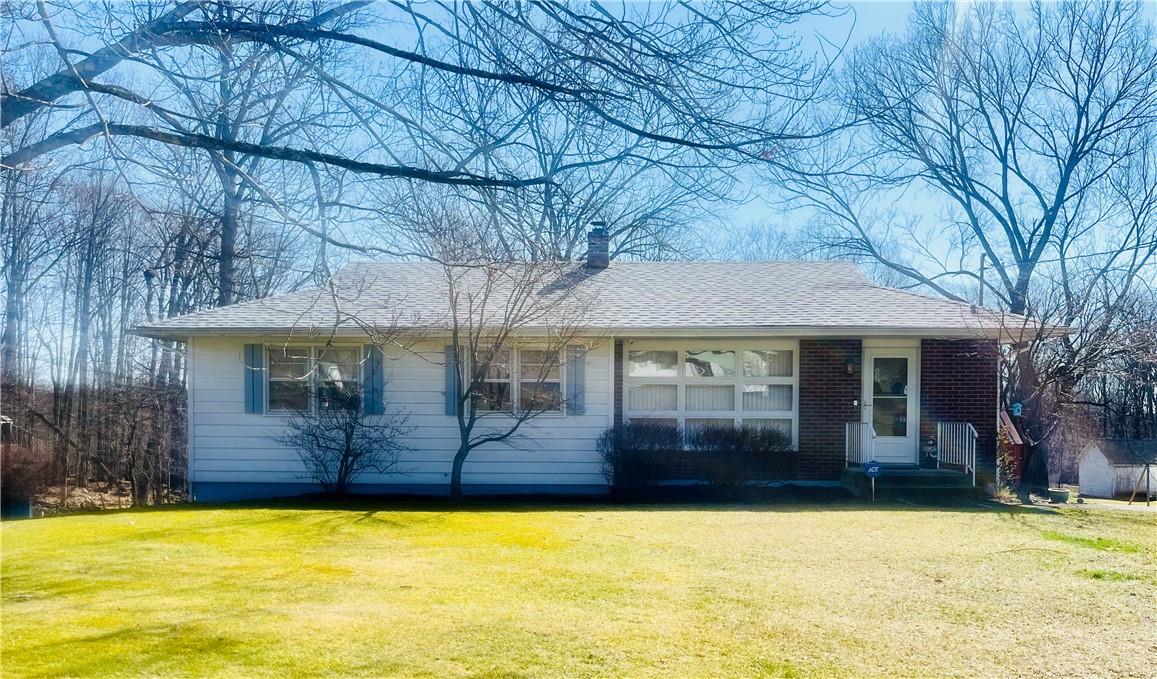 a view of a house with a backyard