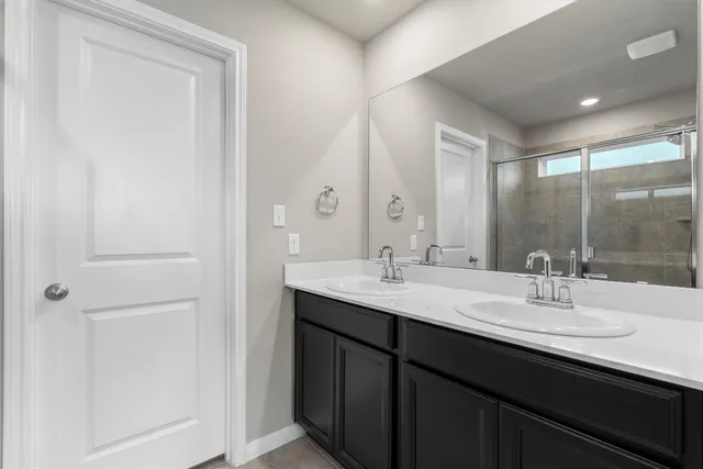 a bathroom with a sink double vanity and a mirror