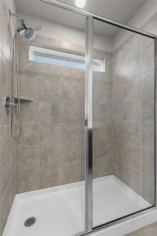 a bathroom with a shower and a bathtub
