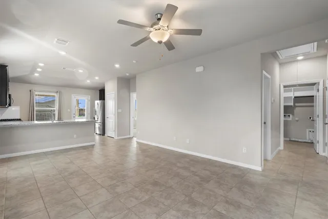 a view of an empty room with a ceiling fan