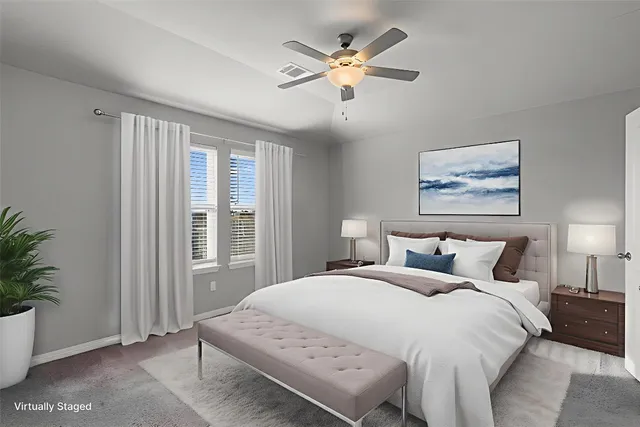 a bedroom with a large bed chandelier and a window