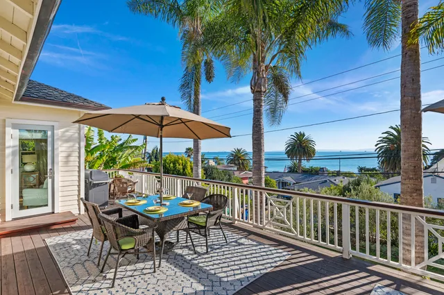 a view of a chair and tables in the balcony