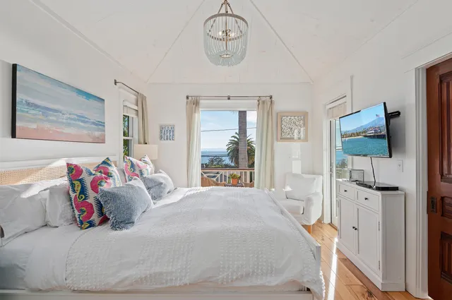 a bedroom with a bed and a mirror