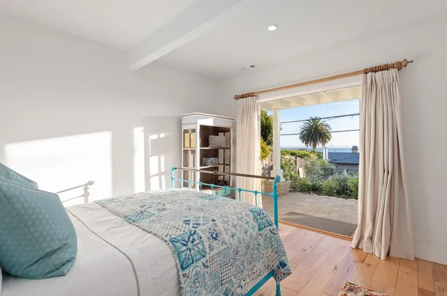 a bedroom with a large bed and a large window