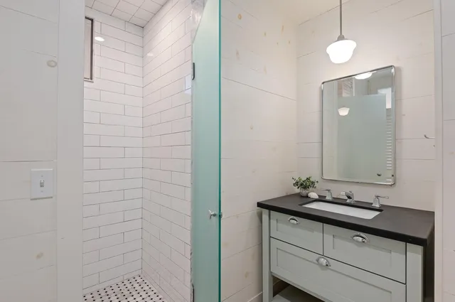 a bathroom with a sink a vanity and a mirror