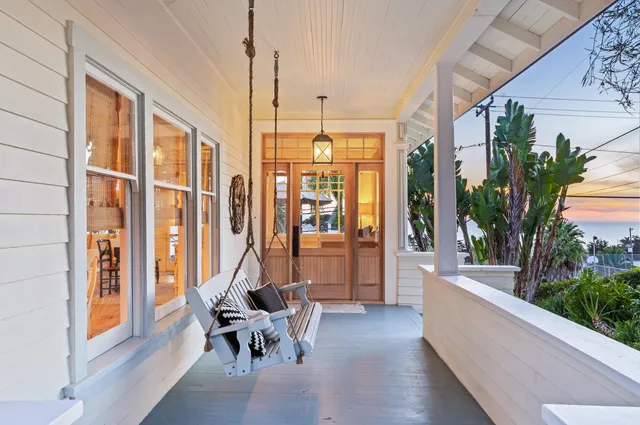 a living room with furniture and large windows
