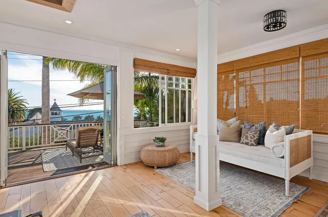 a living room with furniture and a floor to ceiling window